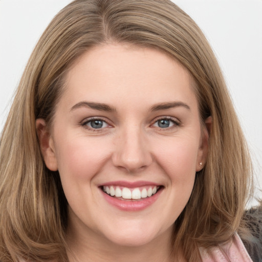 Joyful white young-adult female with long  brown hair and grey eyes