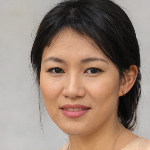 Joyful asian young-adult female with medium  brown hair and brown eyes