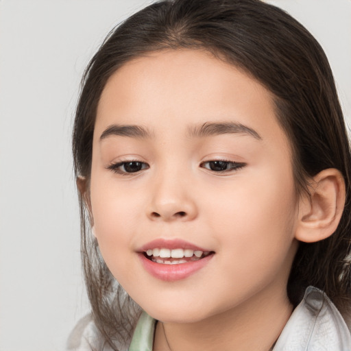 Joyful white child female with medium  brown hair and brown eyes