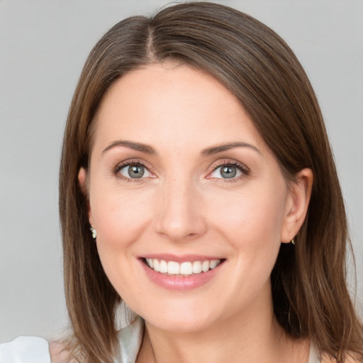 Joyful white young-adult female with medium  brown hair and grey eyes