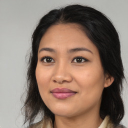 Joyful asian young-adult female with long  brown hair and brown eyes