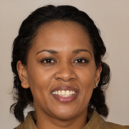 Joyful black adult female with medium  brown hair and brown eyes