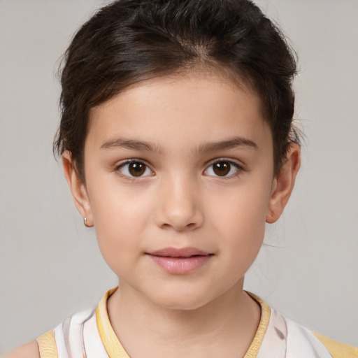 Joyful white child female with short  brown hair and brown eyes