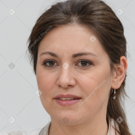 Joyful white adult female with medium  brown hair and brown eyes