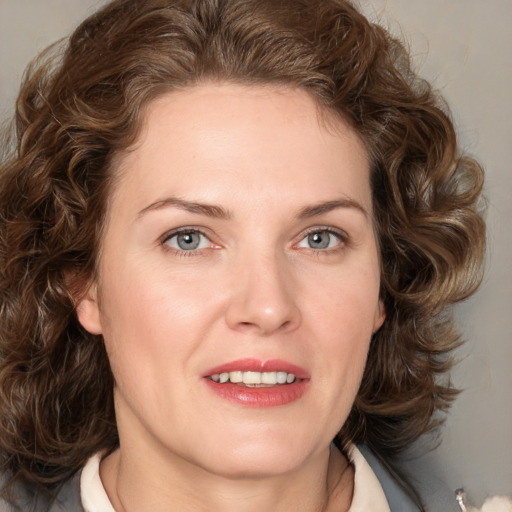 Joyful white young-adult female with medium  brown hair and green eyes