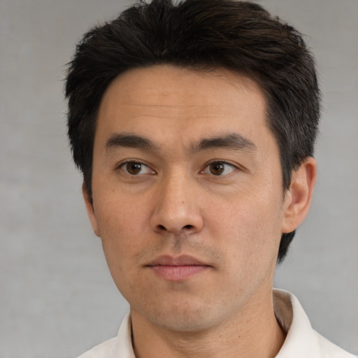 Neutral asian adult male with short  black hair and brown eyes