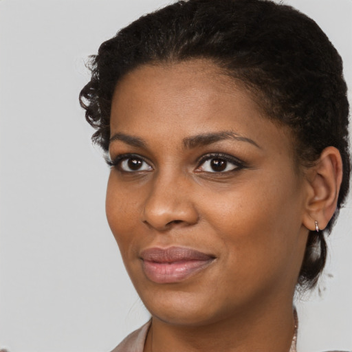 Joyful black young-adult female with short  brown hair and brown eyes