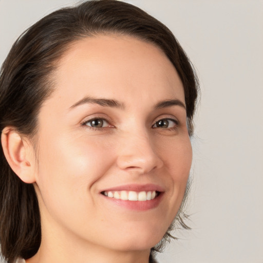 Joyful white young-adult female with medium  brown hair and brown eyes