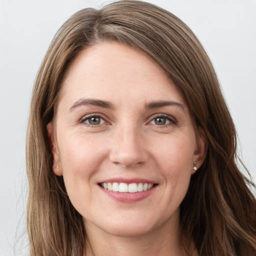 Joyful white young-adult female with long  brown hair and grey eyes