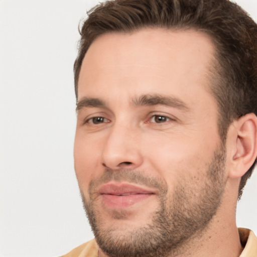 Joyful white young-adult male with short  brown hair and brown eyes