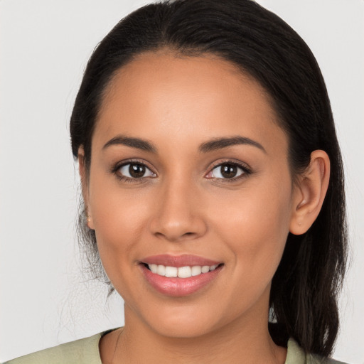 Joyful white young-adult female with long  brown hair and brown eyes