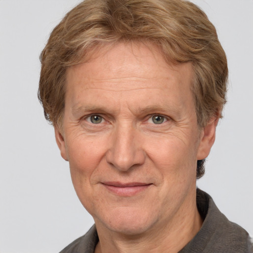 Joyful white middle-aged male with short  brown hair and grey eyes