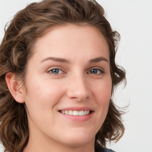 Joyful white young-adult female with long  brown hair and green eyes