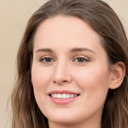 Joyful white young-adult female with long  brown hair and grey eyes