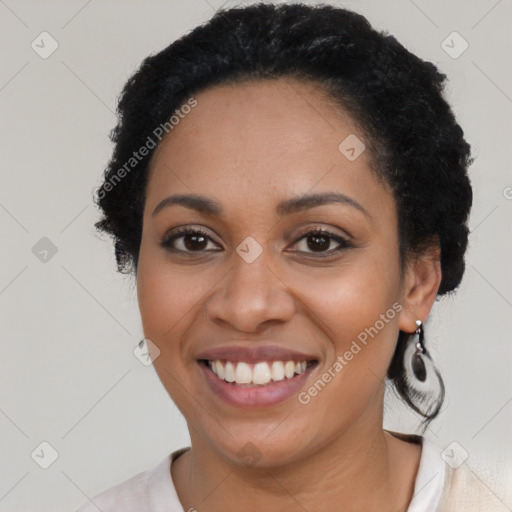 Joyful black young-adult female with short  brown hair and brown eyes