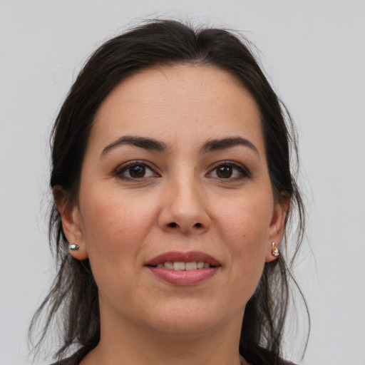 Joyful white adult female with medium  brown hair and brown eyes