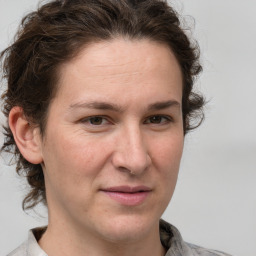 Joyful white adult female with medium  brown hair and grey eyes