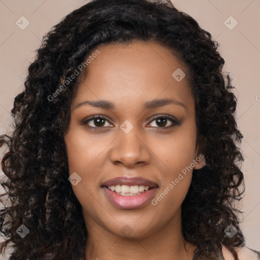 Joyful black young-adult female with long  black hair and brown eyes