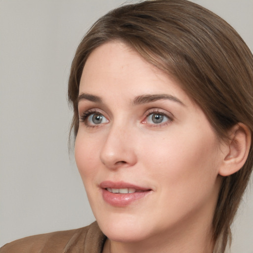 Joyful white young-adult female with medium  brown hair and grey eyes