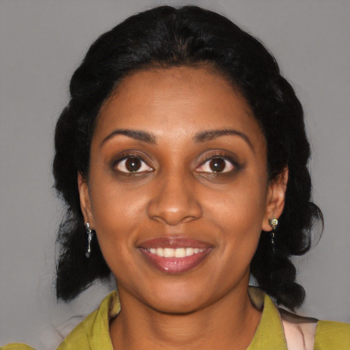 Joyful black young-adult female with medium  black hair and brown eyes
