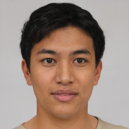 Joyful asian young-adult male with short  black hair and brown eyes