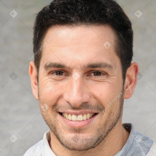 Joyful white adult male with short  brown hair and brown eyes