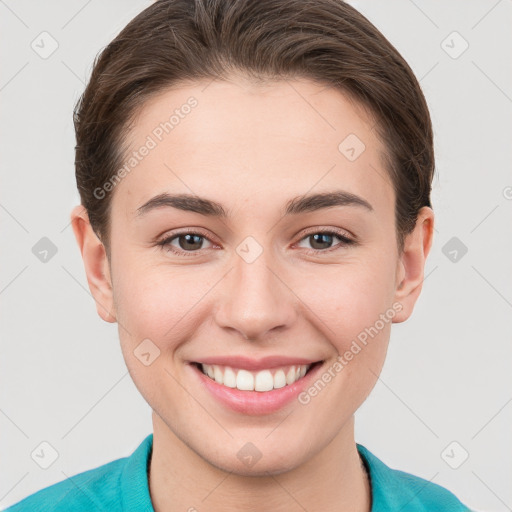 Joyful white young-adult female with short  brown hair and grey eyes