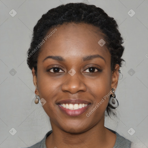 Joyful black young-adult female with long  black hair and brown eyes