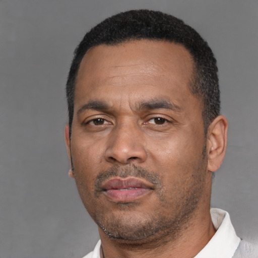 Neutral black adult male with short  black hair and brown eyes