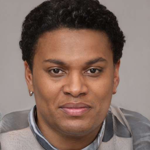 Joyful latino young-adult male with short  brown hair and brown eyes