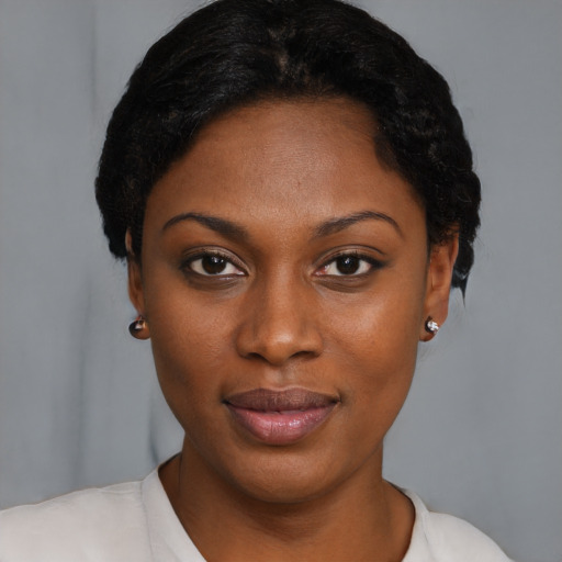 Joyful black young-adult female with short  brown hair and brown eyes