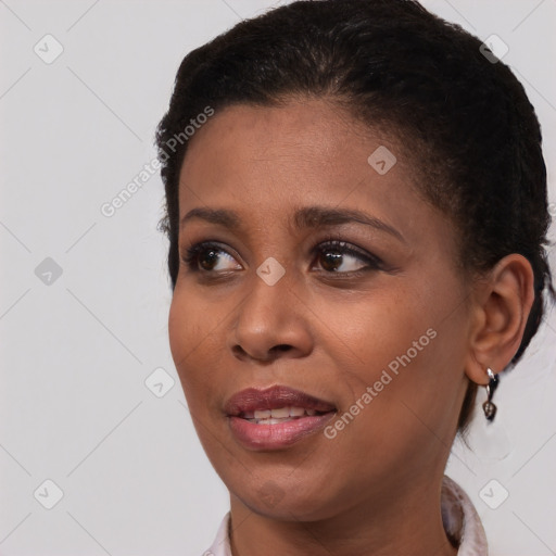 Joyful black young-adult female with short  brown hair and brown eyes