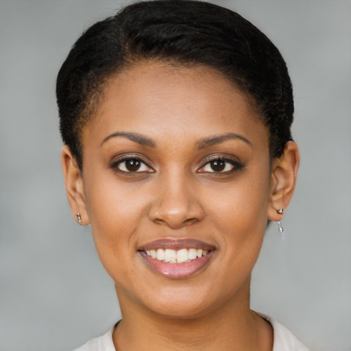 Joyful black young-adult female with short  brown hair and brown eyes