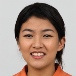 Joyful asian young-adult female with medium  black hair and brown eyes