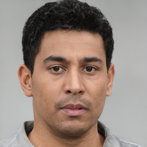Neutral latino young-adult male with short  black hair and brown eyes