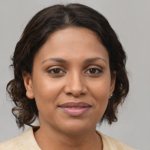 Joyful white adult female with medium  brown hair and brown eyes