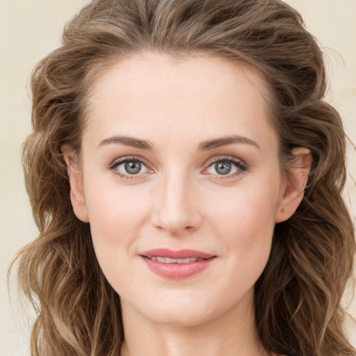 Joyful white young-adult female with long  brown hair and blue eyes