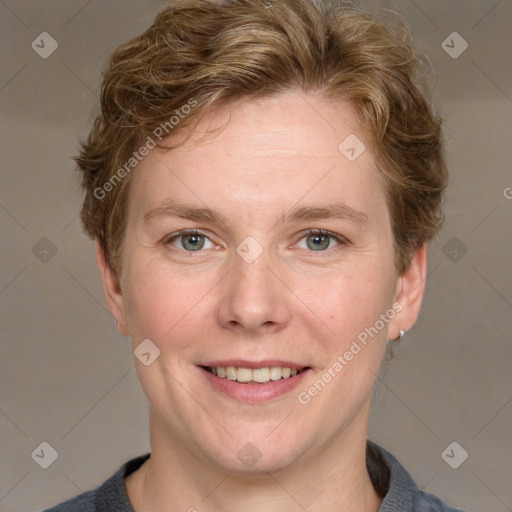 Joyful white adult female with short  brown hair and blue eyes