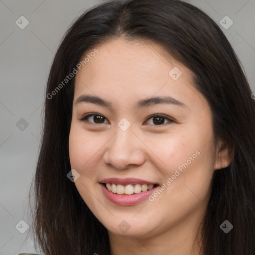 Joyful asian young-adult female with long  brown hair and brown eyes