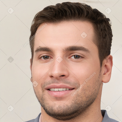 Joyful white young-adult male with short  brown hair and brown eyes