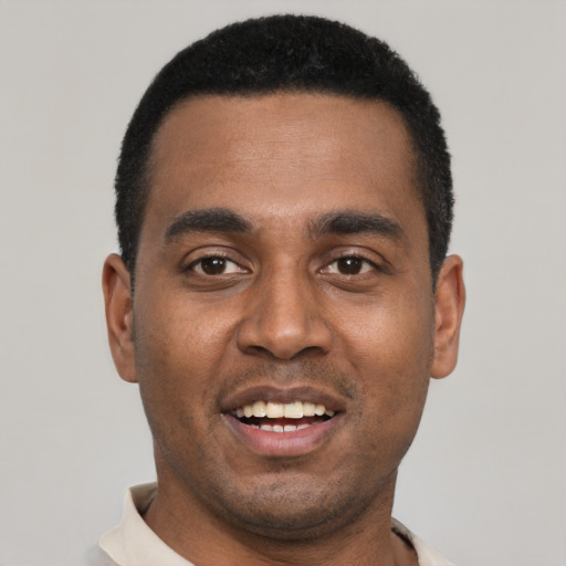 Joyful black young-adult male with short  black hair and brown eyes