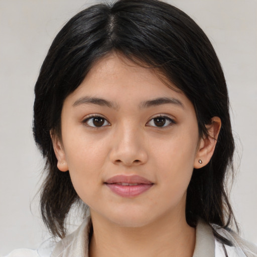 Joyful latino young-adult female with medium  brown hair and brown eyes
