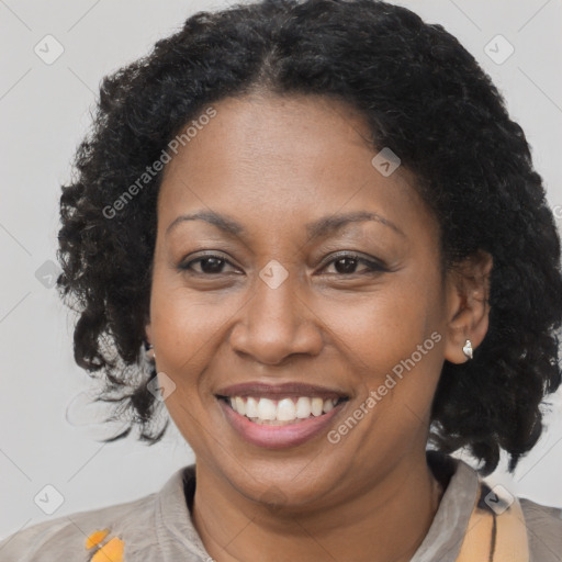 Joyful black adult female with medium  brown hair and brown eyes