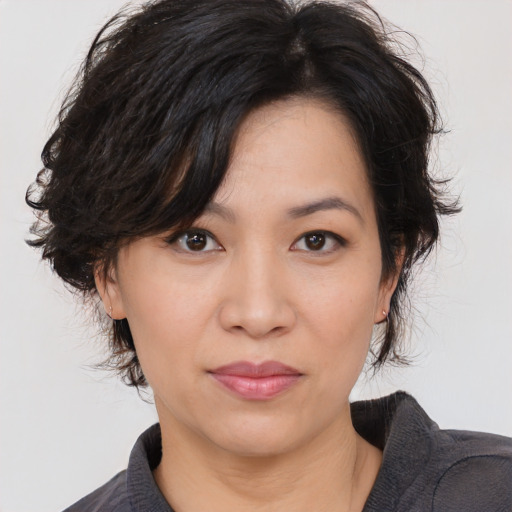 Joyful asian young-adult female with medium  black hair and brown eyes
