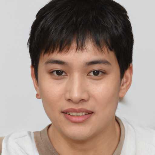 Joyful asian young-adult male with short  brown hair and brown eyes
