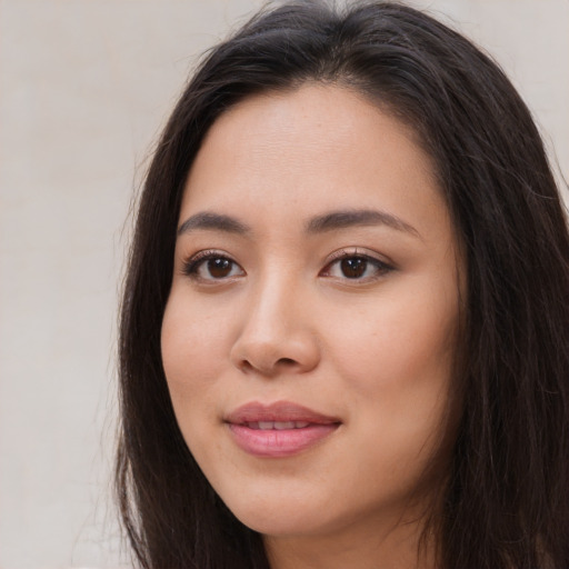 Joyful asian young-adult female with long  brown hair and brown eyes