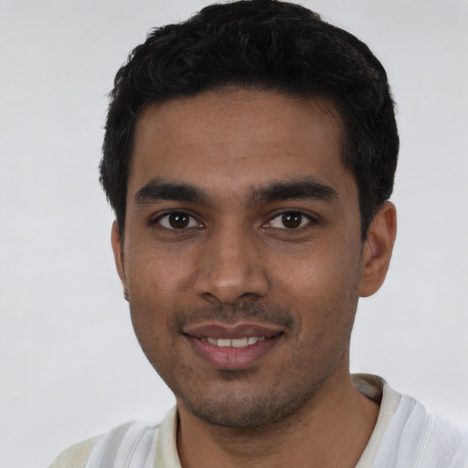 Joyful latino young-adult male with short  black hair and brown eyes