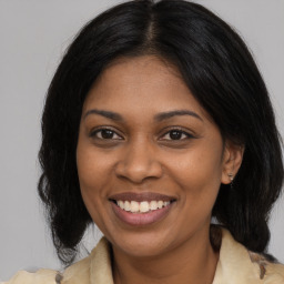 Joyful black young-adult female with medium  brown hair and brown eyes