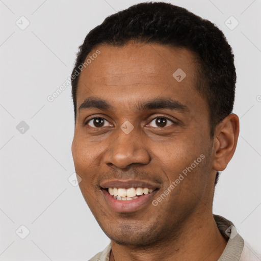 Joyful black young-adult male with short  black hair and brown eyes