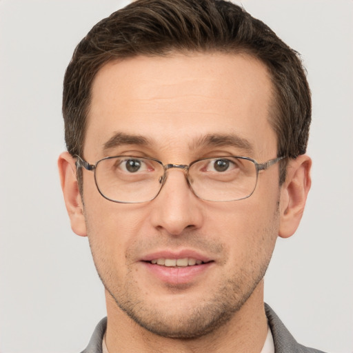 Joyful white adult male with short  brown hair and grey eyes